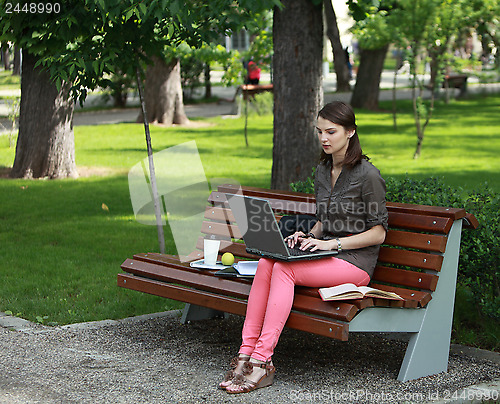 Image of Young Woman Studying in a Park
