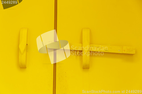 Image of Yellow wooden door bar