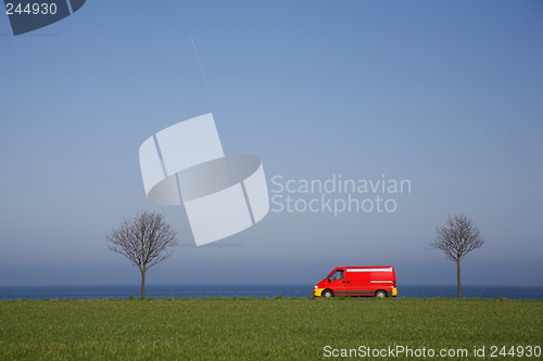 Image of Red van in spring landscape