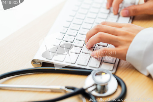 Image of Doctor typing keyboard with stethoscope