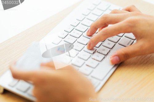 Image of Online shopping with credit card and keyboard