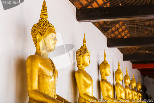 Image of Golden Buddha in a row