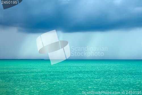 Image of Storm rain clouds over the turquoise sea