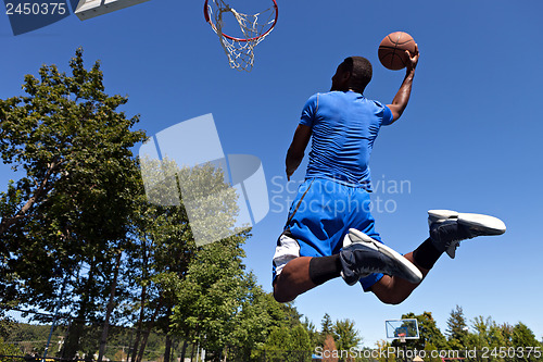 Image of Man Dunking a Basketball