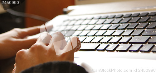 Image of Young woman working on laptop