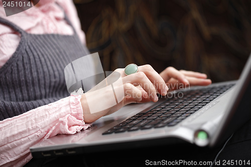 Image of Young woman working on laptop