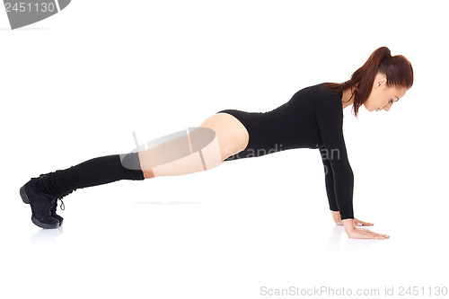 Image of Athletic young woman doing press ups