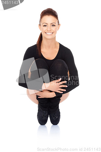 Image of Smiling woman balancing on her toes