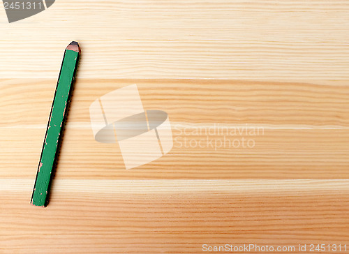 Image of Green carpentry pencil on wood