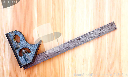 Image of Metal set square on wood