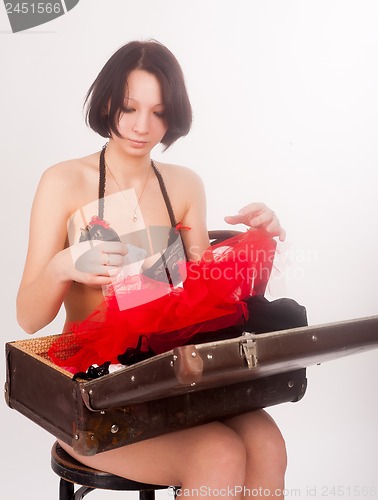 Image of Pretty girl in lingerie with  suitcase