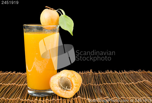 Image of Glass apricot juice and fruits black isolated.