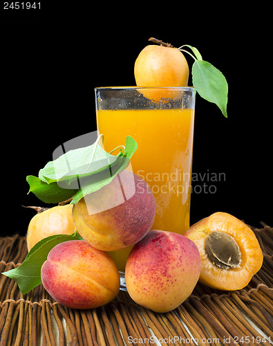 Image of Glass apricot juice and fruits black isolated.