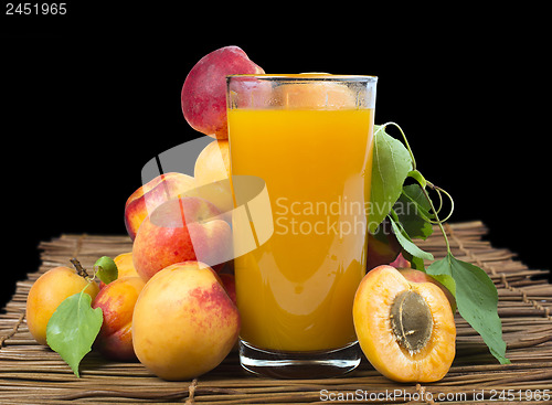 Image of Glass apricot juice and fruits black isolated.