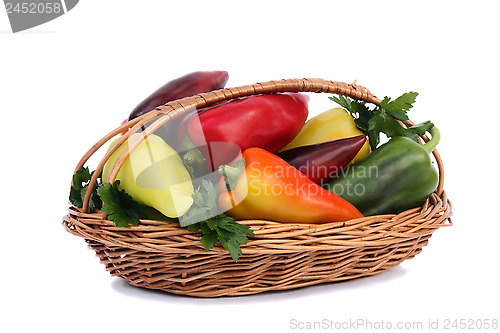 Image of Red, yellow and green pepper in a basket on a white background.