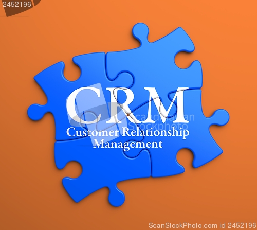Image of CRM on Blue Puzzle Pieces. Business Concept.