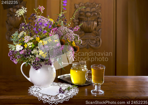 Image of Still life from medicinal herbs, honey, herbal tea
