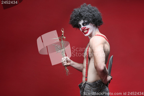 Image of Spooky Clown Portrait on Red Background