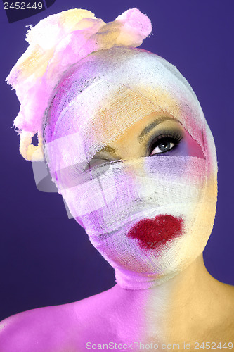 Image of Extreme Beauty Concept of Heavy Makeup Seeping Through Gauze