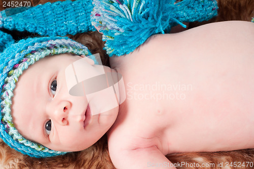 Image of Newborn baby in blue knitted hat