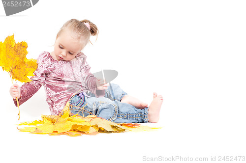 Image of Cute little girl with maple leaves