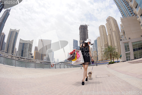 Image of beautiful woman goes in shopping