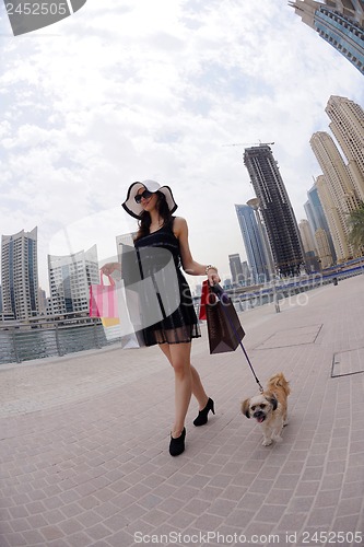 Image of beautiful woman goes in shopping