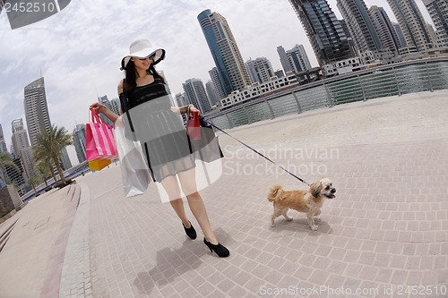 Image of beautiful woman goes in shopping