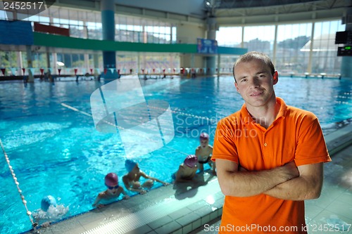 Image of happy children group  at swimming pool