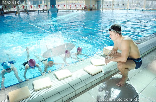 Image of happy children group  at swimming pool