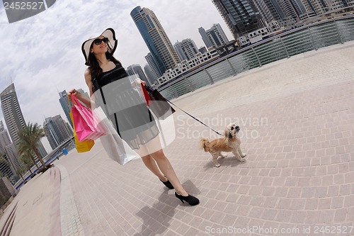 Image of beautiful woman goes in shopping