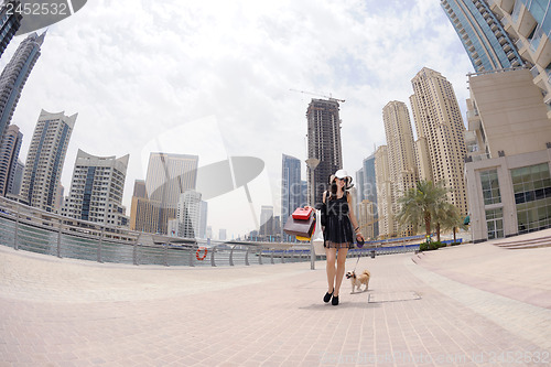 Image of beautiful woman goes in shopping