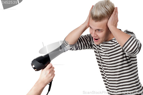 Image of Portrait of man and hairdryer