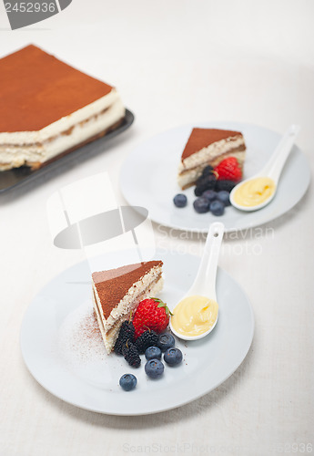 Image of tiramisu dessert with berries and cream