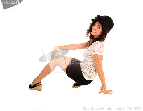 Image of Girl crouching on floor.