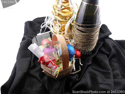 Image of bottle of champagne, christmas balls and white invitation paper