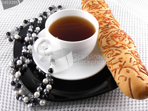 Image of breakfast with coffee cup, sweet bread and diamond