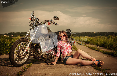 Image of Biker girl and motorcycle