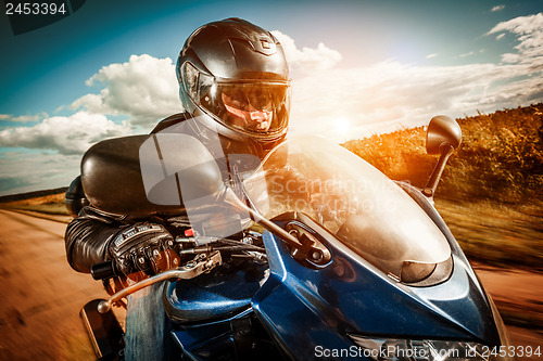 Image of Biker racing on the road