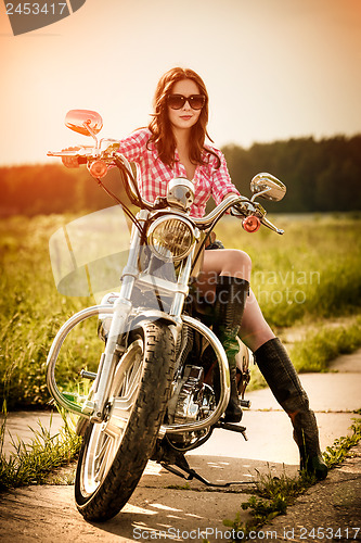 Image of Biker girl and motorcycle