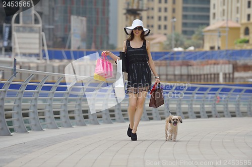 Image of beautiful woman goes in shopping