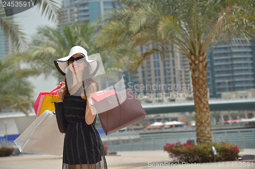 Image of beautiful woman goes in shopping