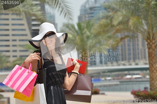 Image of beautiful woman goes in shopping