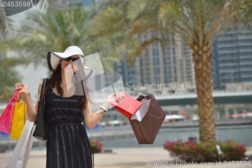 Image of beautiful woman goes in shopping