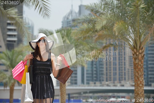 Image of beautiful woman goes in shopping