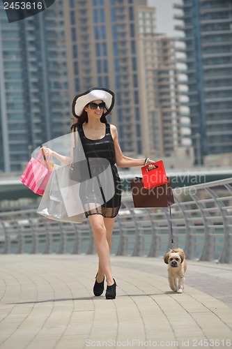Image of beautiful woman goes in shopping