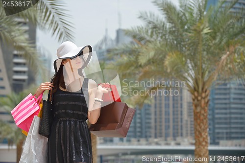 Image of beautiful woman goes in shopping