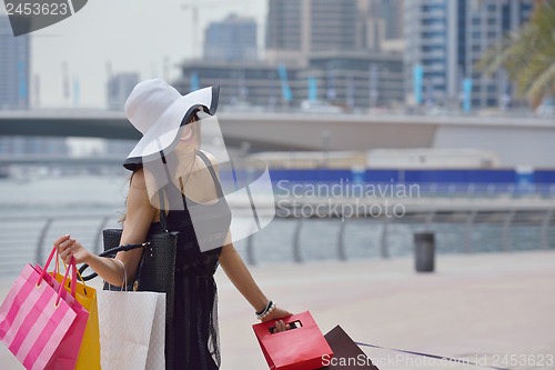 Image of beautiful woman goes in shopping