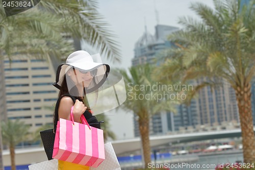 Image of beautiful woman goes in shopping