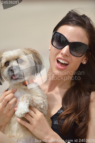 Image of happy young woman with puppy have fun